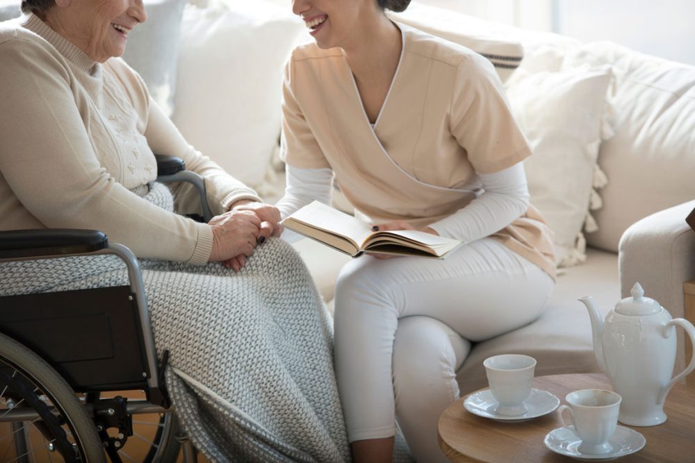 Care giver and a senior in a wheelchair