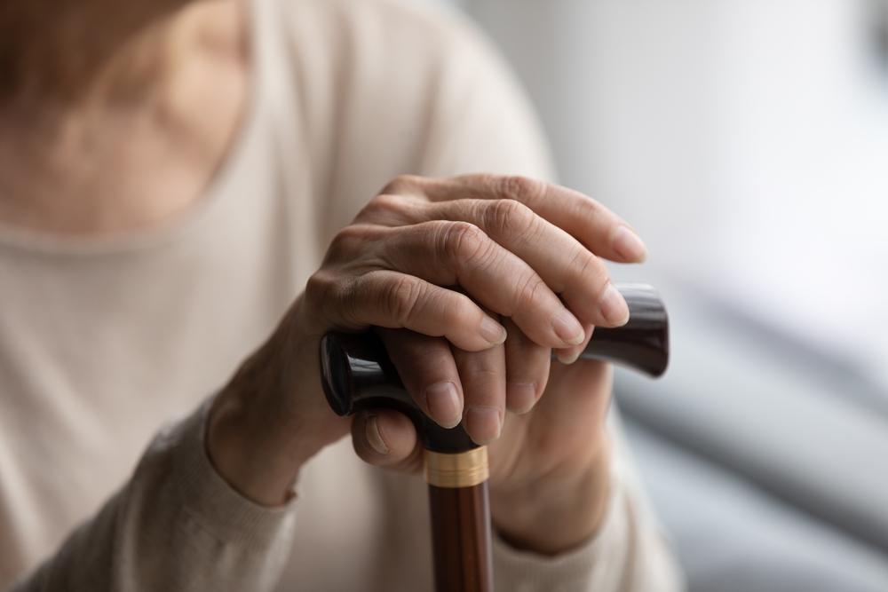 Resident holding walking stick